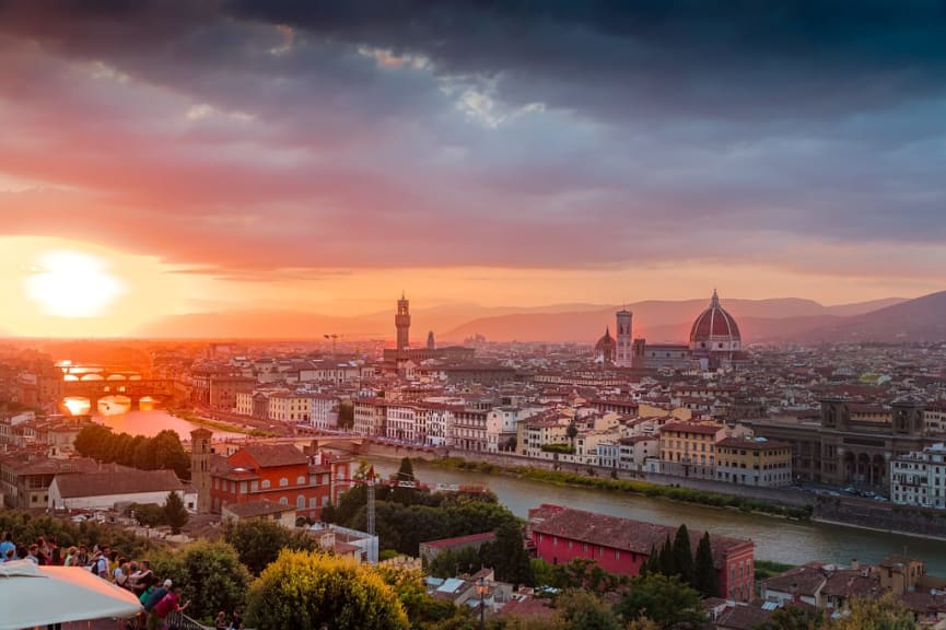 Skyline of Florence, with the Domes of Cathedral of Santa Maria del Fiore and the Vecchio Bridge at sunset in Italy