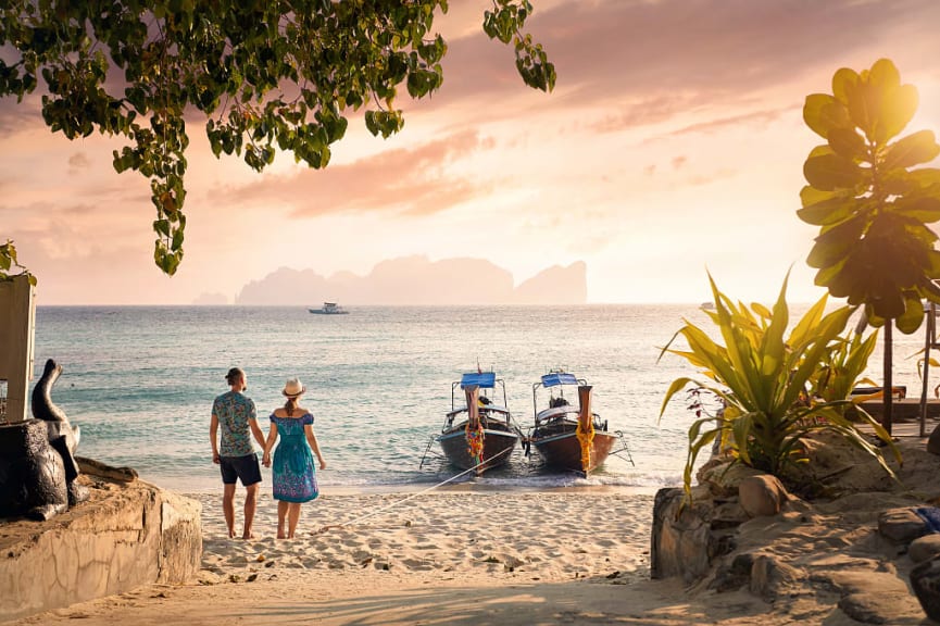 Couple at the beach on Phi Phi island at sunset in southern Thailand