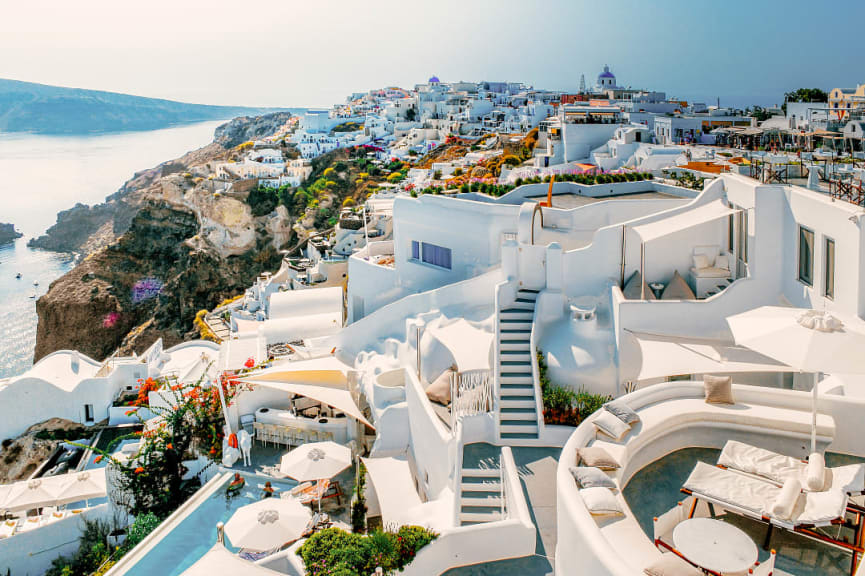 Couple lounging in a resort pool in Oia Village on Santorini, Greece