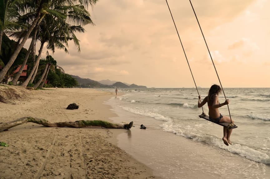 Woman on a swing at a beach on Koh Chang island, Thailand