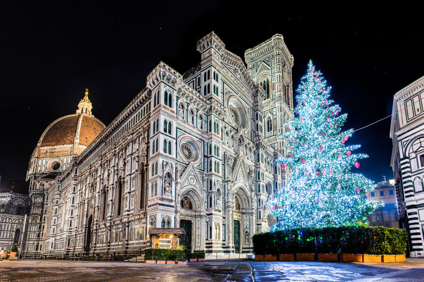 Christmas tree light up at night, in front of the Duomo in Florence, Italy