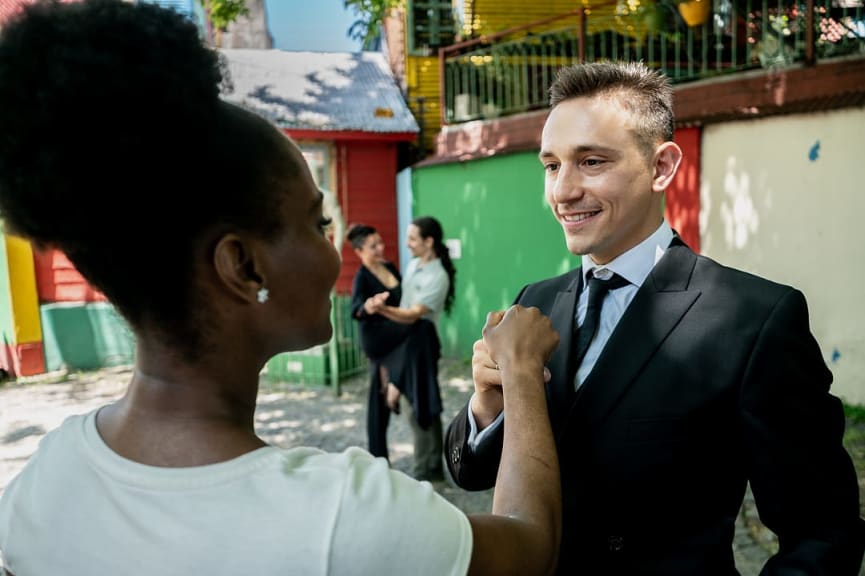 Man teaching tango to tourist in La Boca, Buenos Aires, Argentina