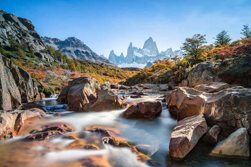 Autumn foliage on the river banks in Argentinian Patagonia with Mt Fitz Roy in the background