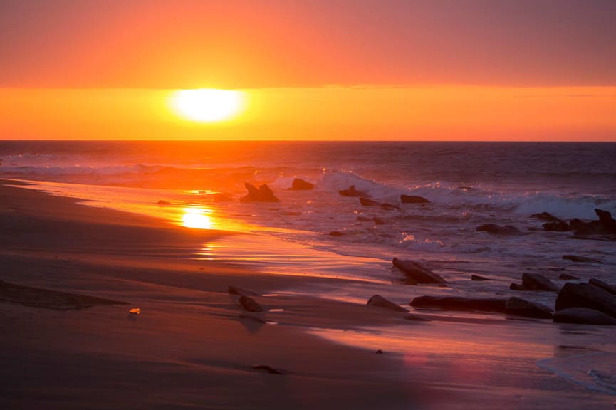 Beautiful orange and purple sunset on the beach of Punta Sal, near Mancora, Peru