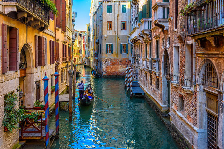 Gondolier navigating the canals in Venice, Italy