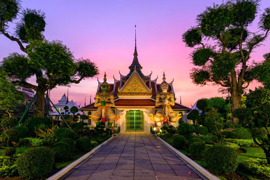 Giant statues and pagoda at Wat Arun in Bangkok Thailand.