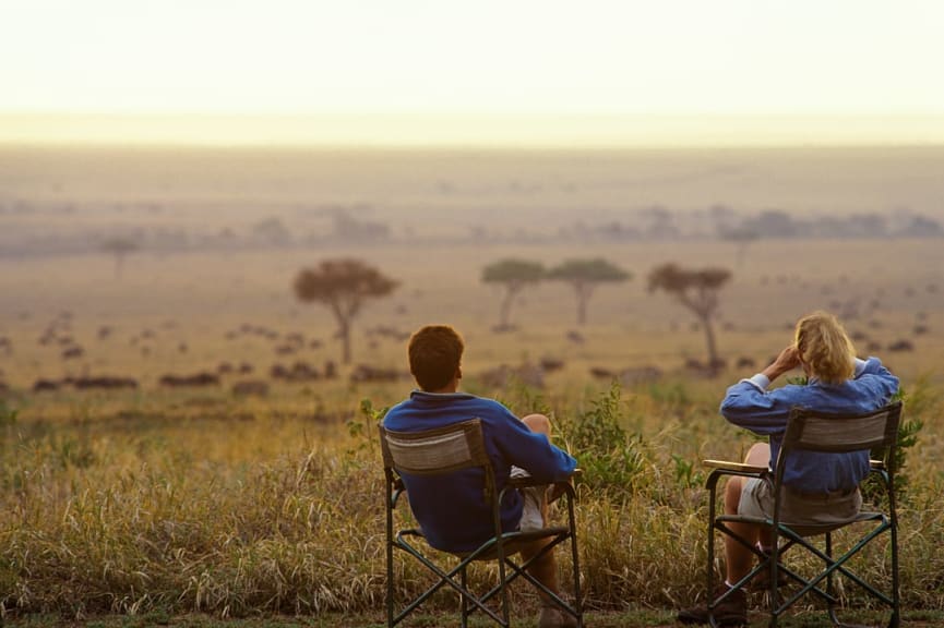 Couple on viewing wildlife on the savannah in Keyna