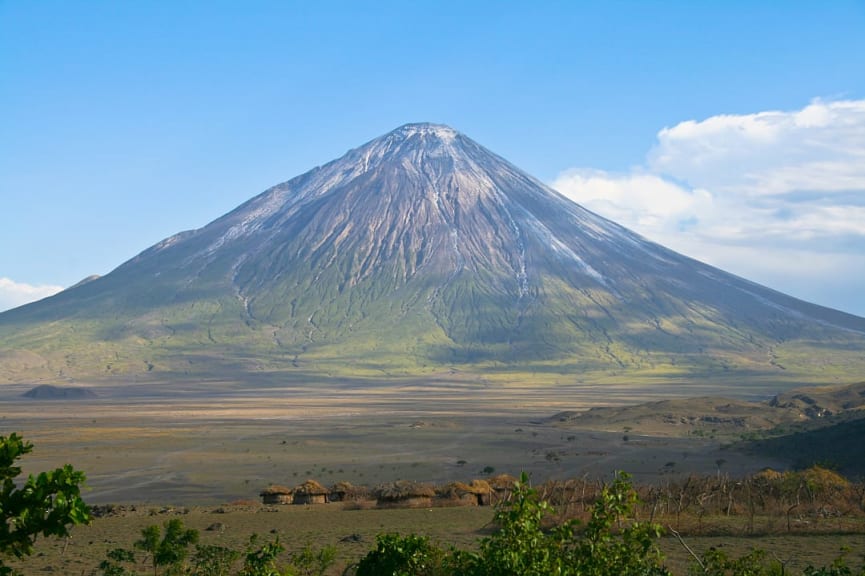 Ol Doinyo Lengai volcano and Maasai village in Tanzania