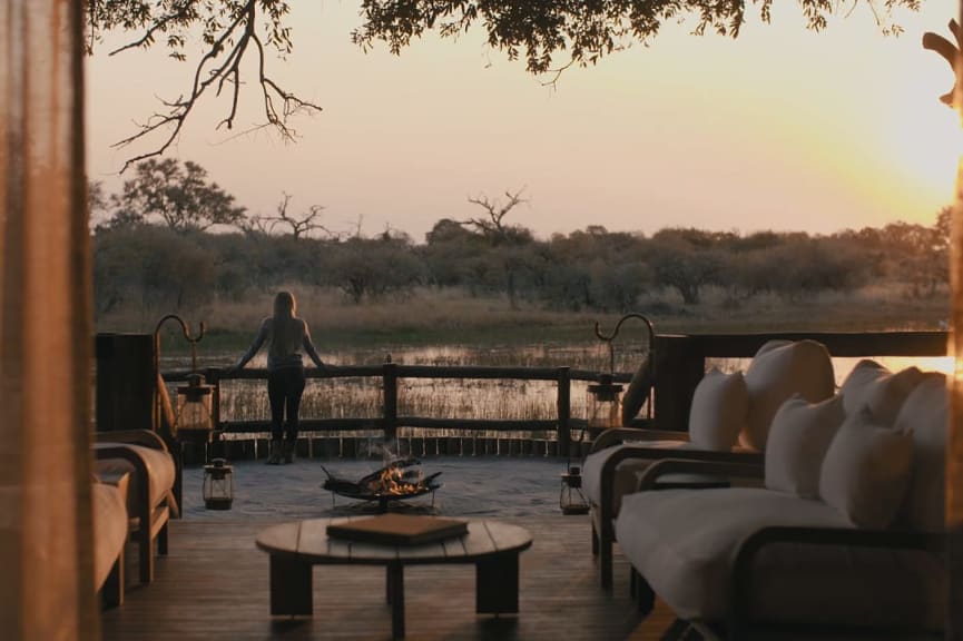 Woman on a terrace overlooking the water in the Okavango Delta in Botswana