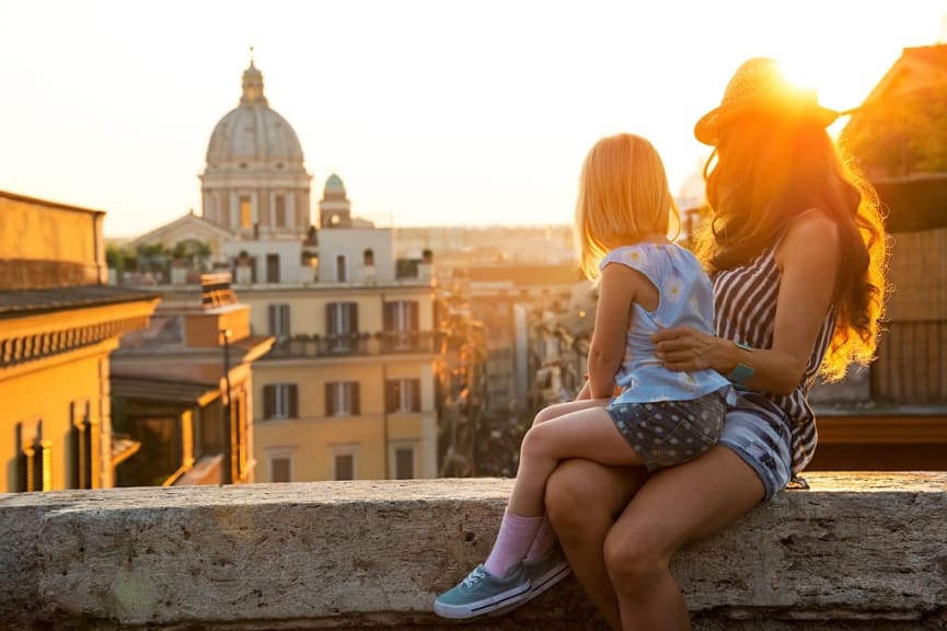 A mother and daughter overlooking the rooftops of Rome.