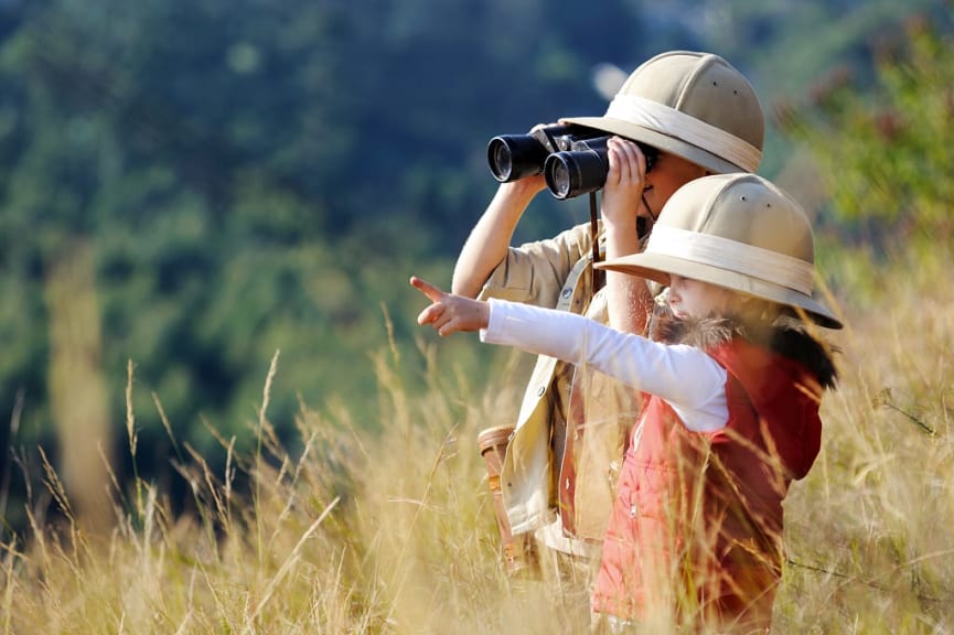 Two kids on dressed for and African safari