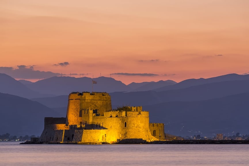 Bourtzi fortress with mountains at sunset in Nafplio, Greece