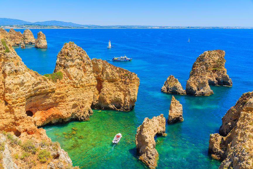 Boats in the turquoise water at Ponta da Piedade in the Algarve region of Portugal