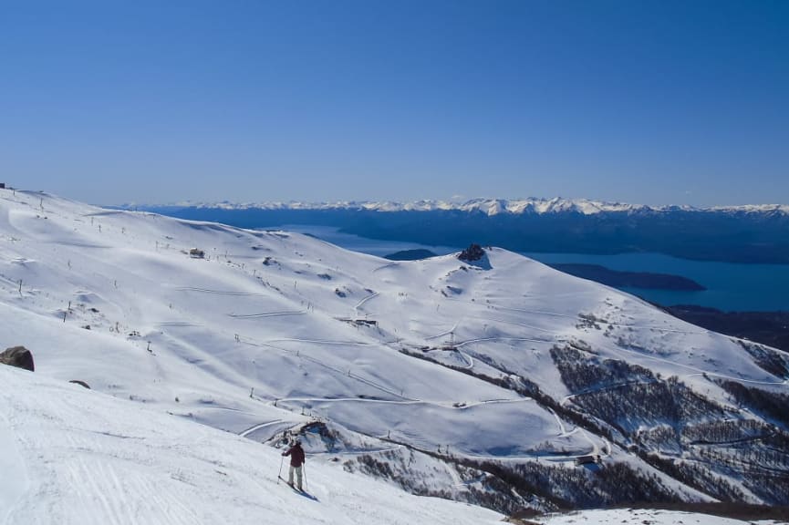 Skier at Cerro Catedral Ski Resort, Bariloche, Argentina, with lake and mountain views