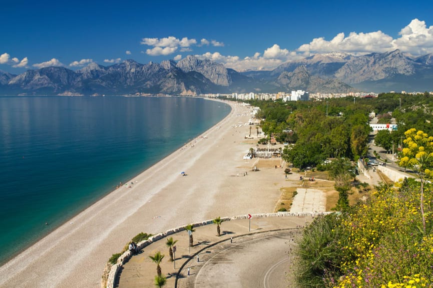 Long stretch of beach with mountains in Antalya, Turkey