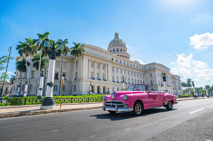 A vintage American convertible car in front of the capitol in Havana, Cuba