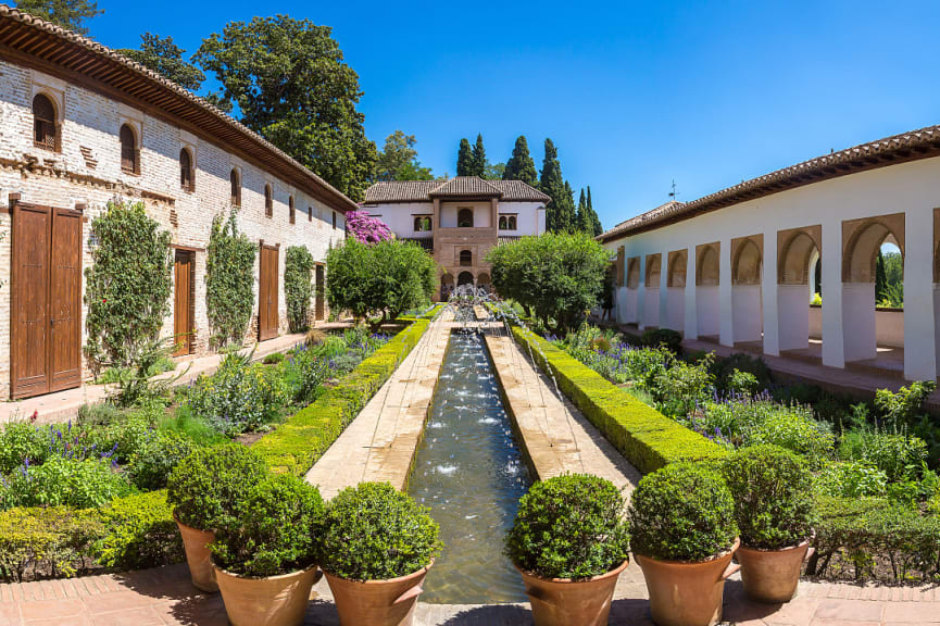 Garden and bell tower at Alhambra Palace in Granada in a beautiful summer day, Spain