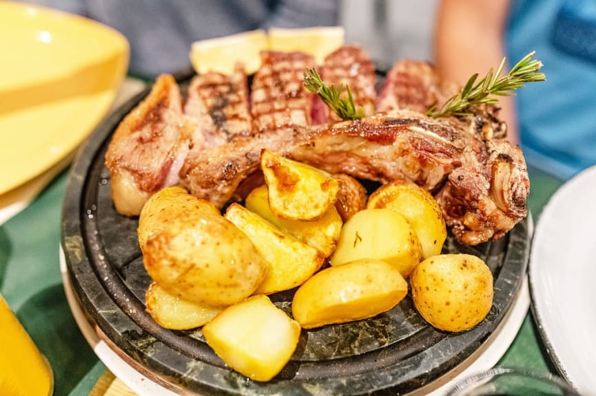 Florentine steak with baked potatoes and rosemary, Tuscany, Italy