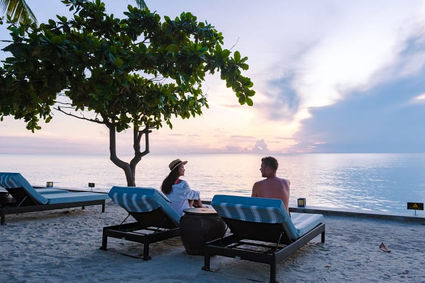 Couple enjoying sunset at Hua Hin beach in Thailand