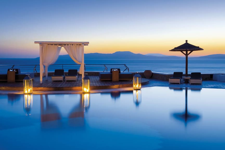 Mykonos Grand Resort pool area at sunset in Greece. Photo courtesy Mykonos Grand Hotel and Resort
