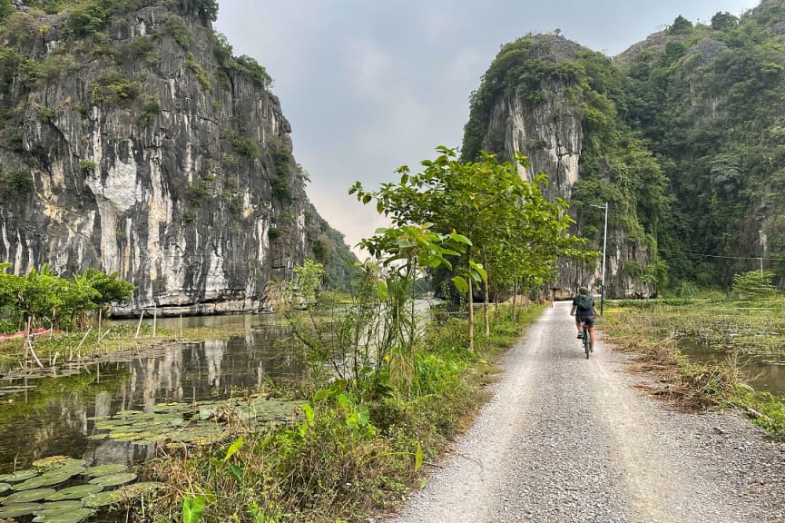 Biker on a path along the river in Ninh Bình