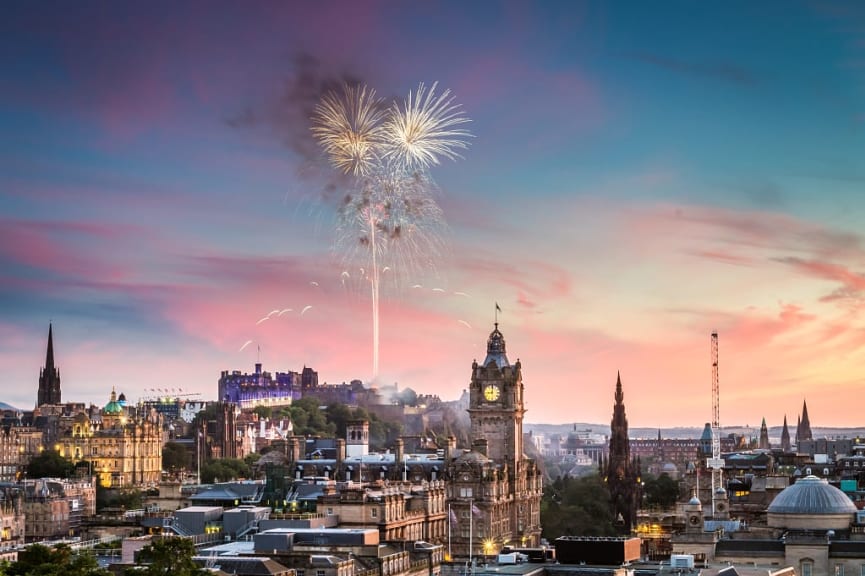 Edinburgh Castle at sunset with fireworks in Scotland 