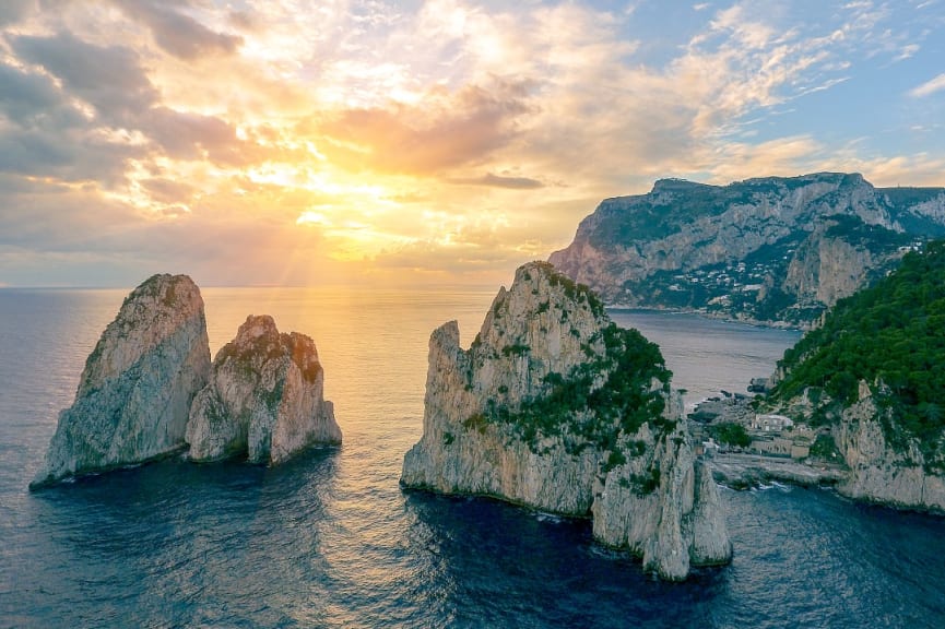 Sunset behind the Faraglioni Rock Formations