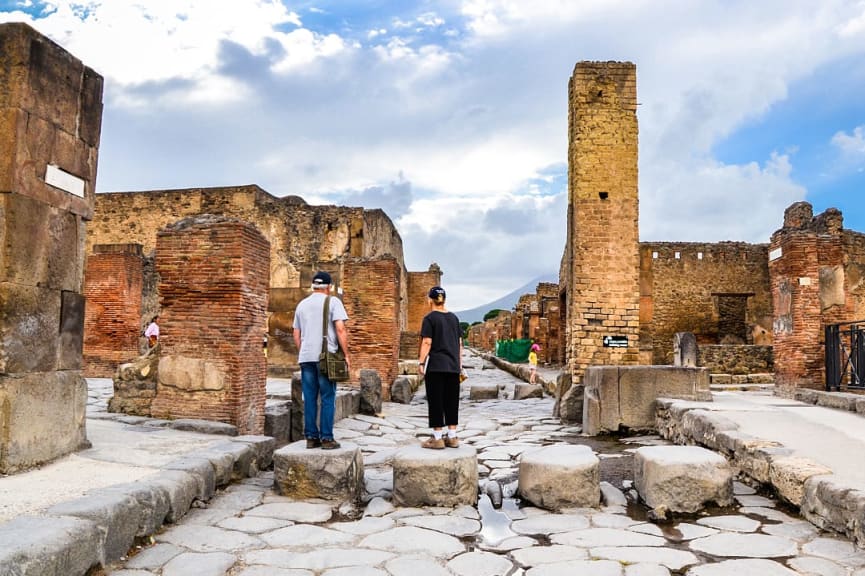 Senior couple in Pompeii ruins in Naples, Italy