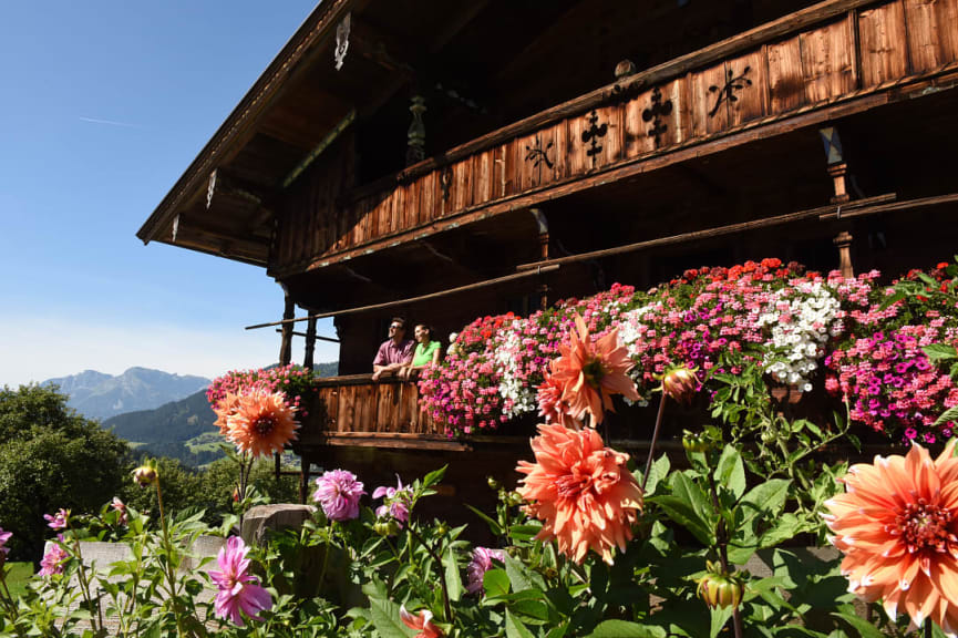 Couple at a farmstead with flowers in Albach, Austria