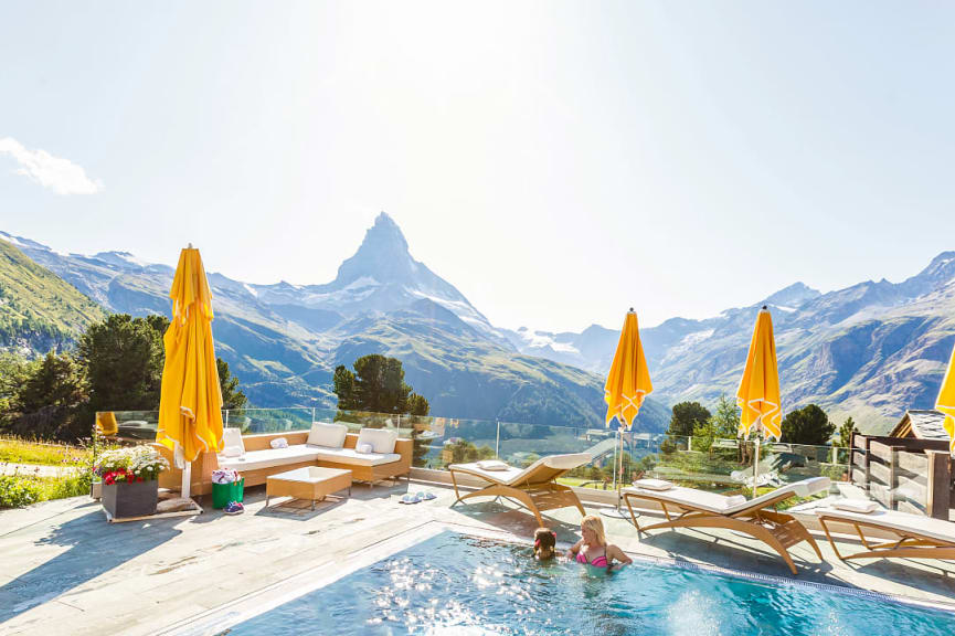 Mother and daughter swimming in outdoor pool in Zermatt