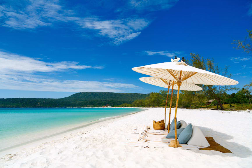 Umbrellas and blankets on white sand beach on Koh Rong Island in Cambodia