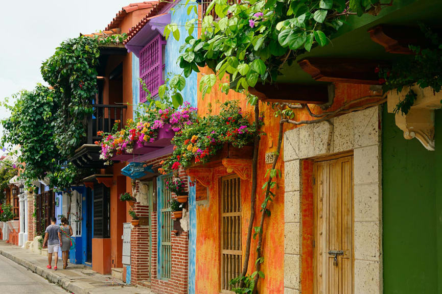 Couple walking through colorful neighborhood in Cartagena, Colombia