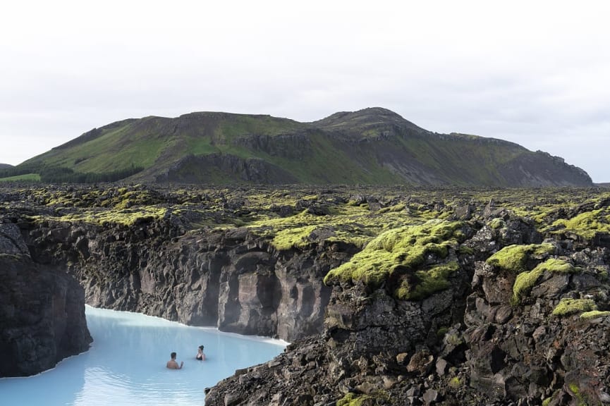 Couple soaking in geothermal hot springs of the Blue Lagoon in Iceland