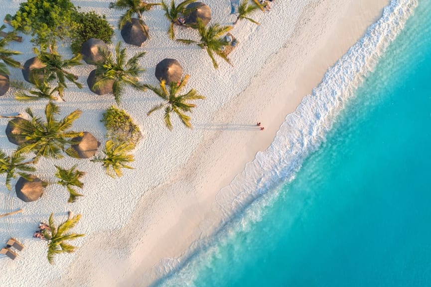 Birds eye view of couple walking on the beach in Zanzibar, Tanzania