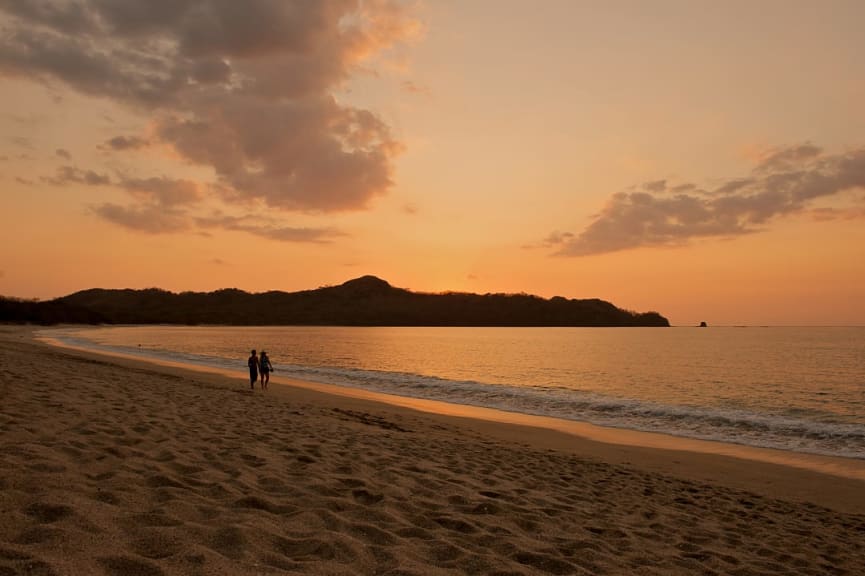 Couple at Playa Conchal at sunset in Guanacaste, Costa Rica