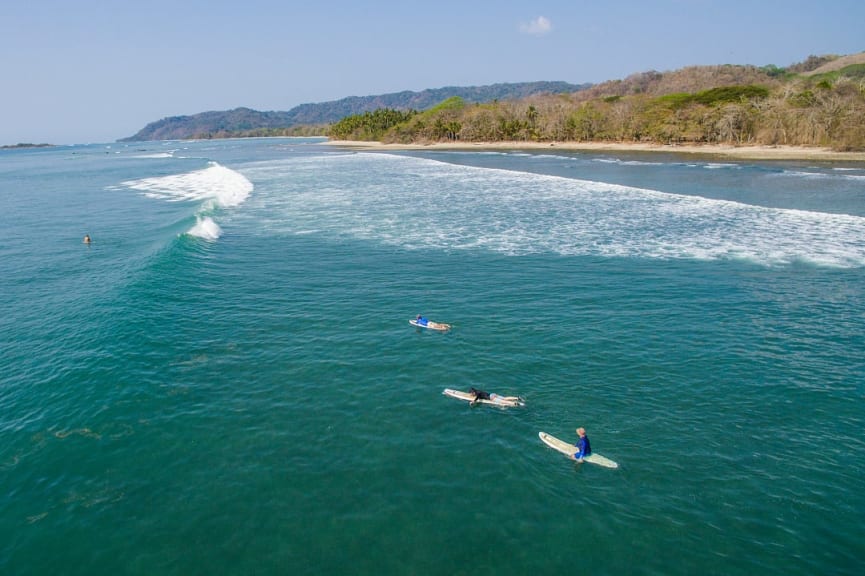 Aerial view of teenagers with surf instructor waiting for a wave in Santa Teresa, Costa Rica