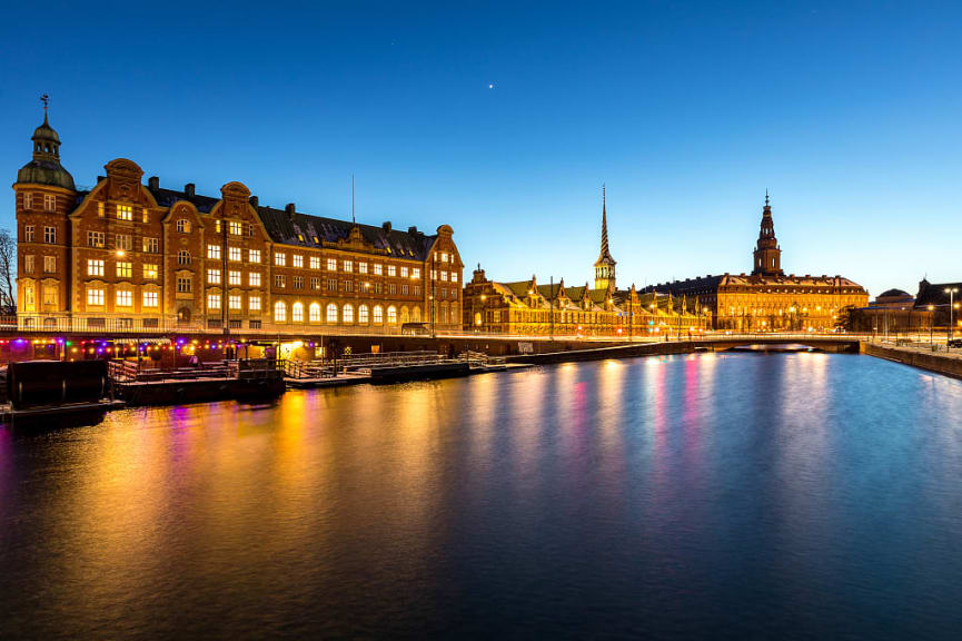 Copenhagen cityscape at twilight with lights reflecting in the waterr