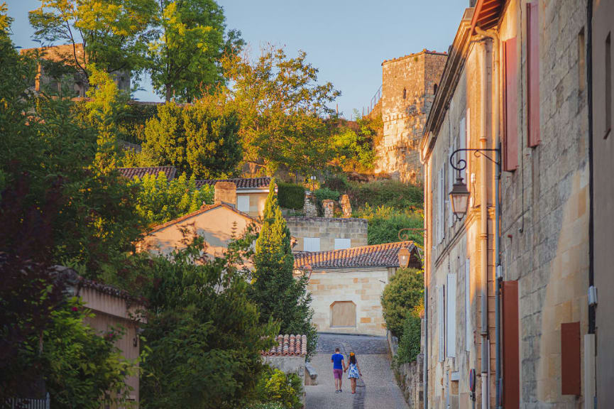 A couple walks through the cobbled streets of the village of Saint-Emilion, Bordeaux