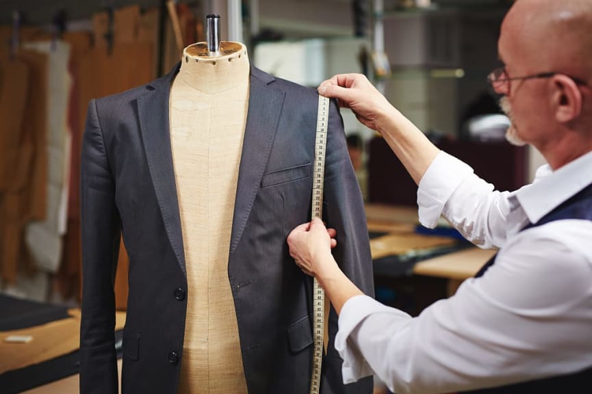 Tailor measuring suit jacket