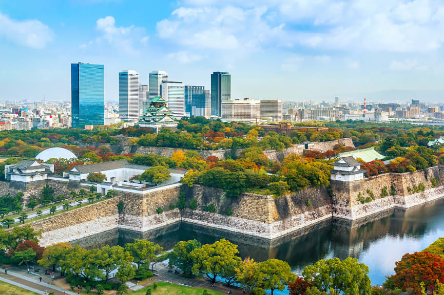 16th century Osaka castle set against the modern skyline of Osaka, Japan