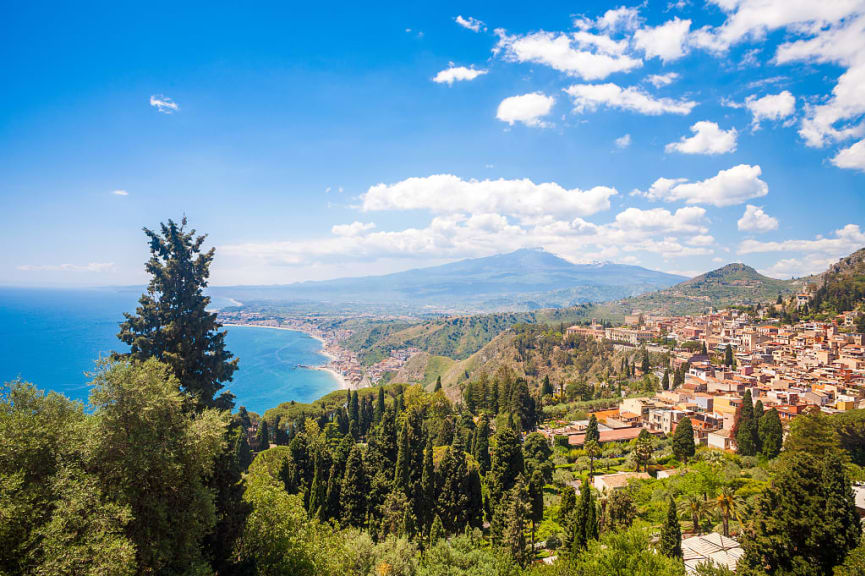 Taormina's Giardini-Naxos bay with Mt Etna and Catania in Sicily, Italy  