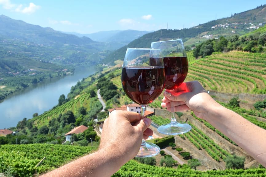Couple toasting with wine glasses in Douro Valley, Portugal
