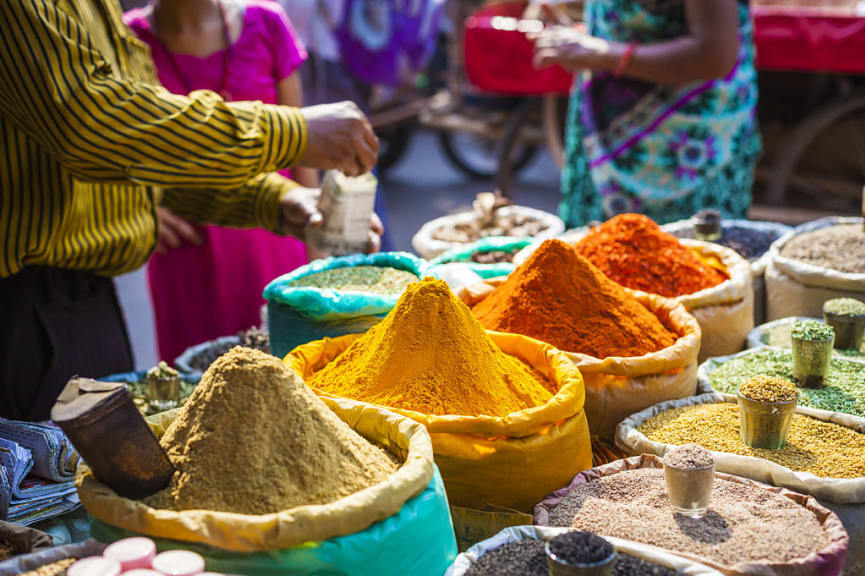 Colorful spices and herbs at a traditional street market in Delhi, India