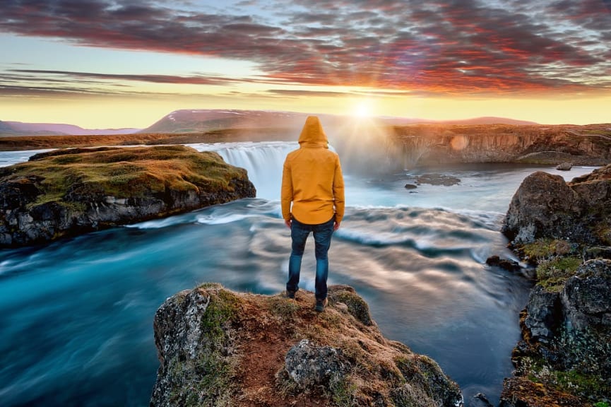 Tourist looking at Godafoss waterfall in Iceland