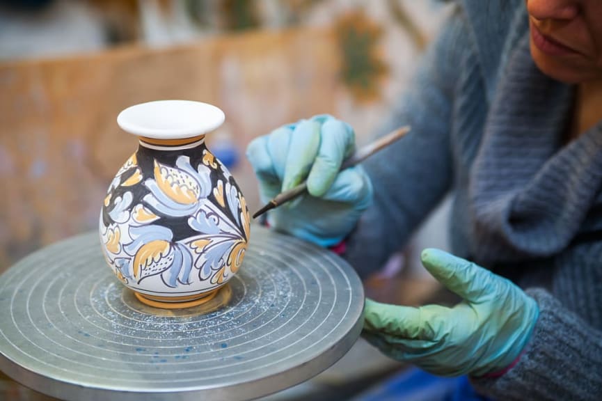 Ceramic vase being decorated b a local artisan in Caltagirone, Italy