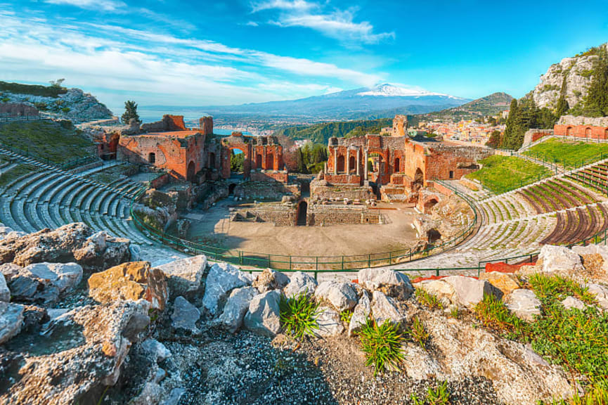 Ruins of an ancient Greek theater. View of Mount Etna. Tarmina, Sicily