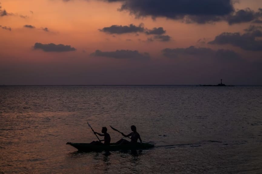 Couple kayaking at sunset in Thailand