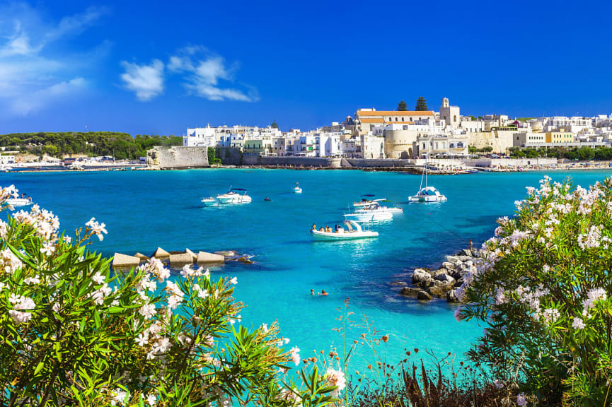 Boats on turquoise water in Otranto, Puglia, Italy 