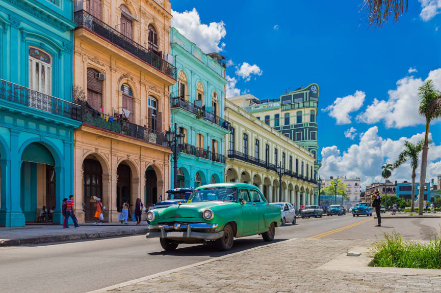 Vintage car on the street with colorful buildings in Havana, Cuba