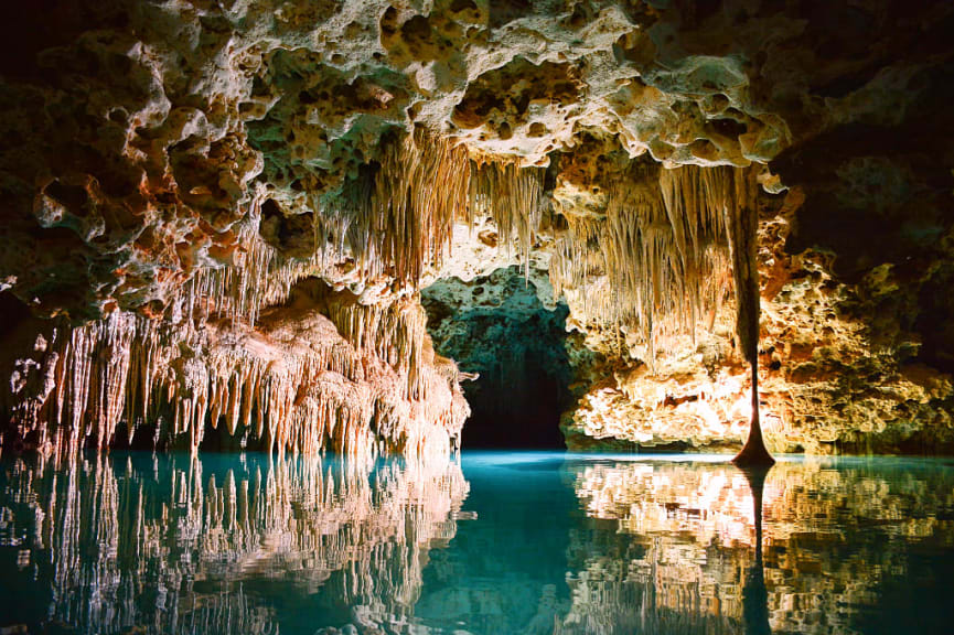 Stalactites and water inside cave in Belize